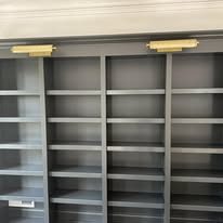 Built-in gray painted bookshelf wall