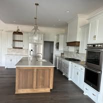 Kitchen with wood island and white cabinets