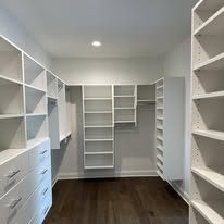 White painted walk-in closet with custom shelving