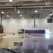 School gymnasium with painted purple bleacher wall and floor