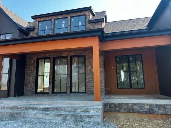 New construction craftsman home exterior, stone and stained wood accents