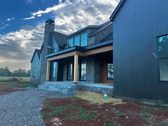 Modern farmhouse exterior with dark siding