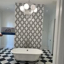Bathroom with checkerboard floor and clawfoot tub