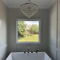 Primary bathroom with freestanding soaking tub and picture window
