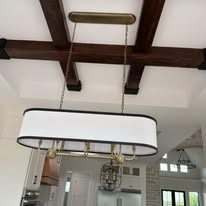 Beamed ceiling great room with chandelier