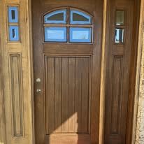 Custom stained wood front entry door with sidelights