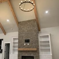 Vaulted great room with stone fireplace and wood beams