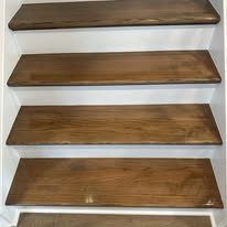 Stained wood stair treads with white risers