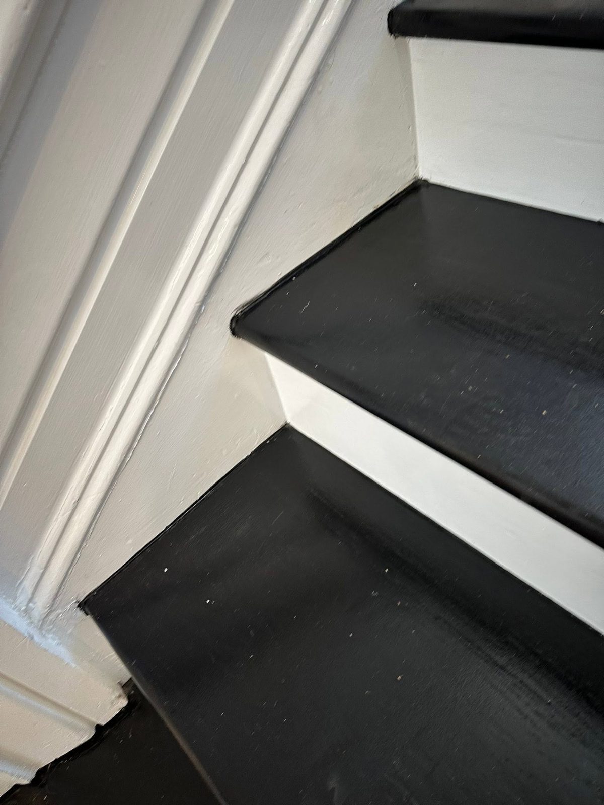 Black and white painted stairwell in a historic remodel